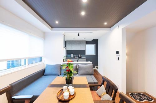a dining room with a table and a couch at Newly Built 3-Story House in the Heart of Tokyo-Easy Access to Airports,Skytree in Tokyo