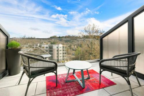 a patio with two chairs and a table on a balcony at Moxy Asheville in Asheville