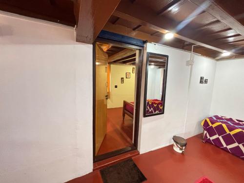 a room with a door leading to a hallway at Grandpa's Vintage Home Stay in Madikeri