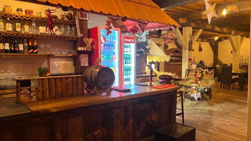 a bar with a blue refrigerator in a room at Belfort- Łomża in Łomża