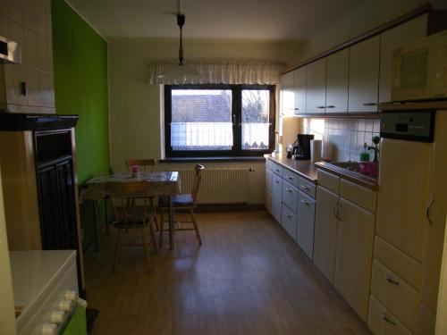 a kitchen with a table and a dining room at unser Ferienhaus in Hempel