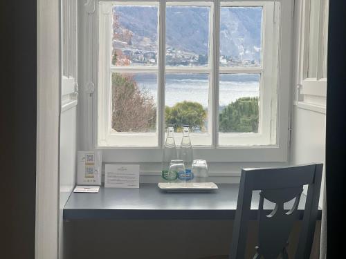 a desk with a chair in front of a window at Hotel Eden Palace au Lac in Montreux