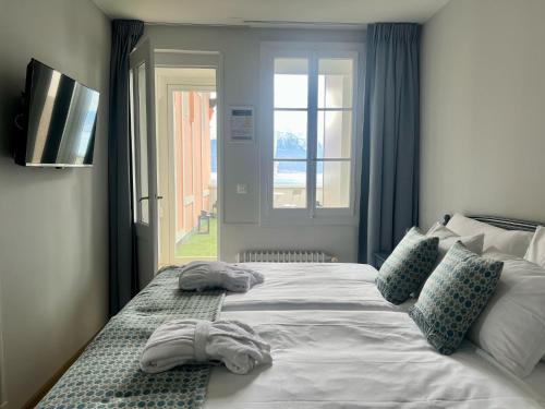 a bedroom with a large bed with towels on it at Hotel Eden Palace au Lac in Montreux