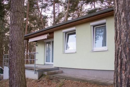 a house with a porch and two windows at Ferienhaus John- Lennard in Amtshof