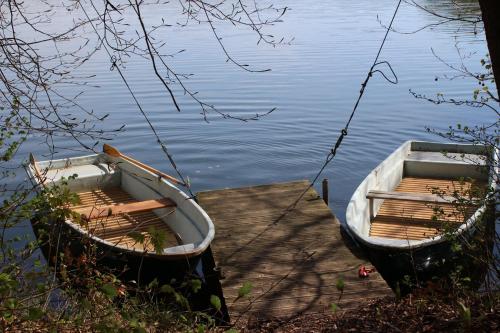 two boats tied up to a dock on the water at Ferienhaus John- Lennard in Amtshof