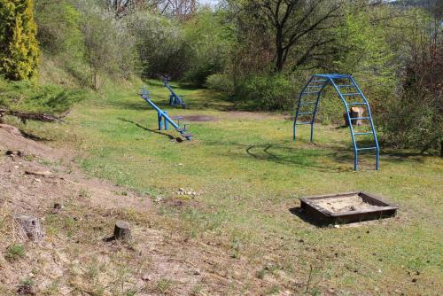 two playground equipment in a grassy field at Ferienhaus Charlotte in Amtshof