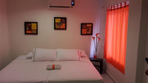 A bed or beds in a room at Manzanillo Beach