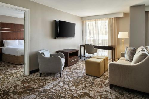 a hotel room with a bed and a living room at Residence Inn Charlotte Uptown in Charlotte
