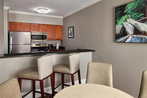 a kitchen with a bar with chairs in a room at Residence Inn Charlotte Uptown in Charlotte