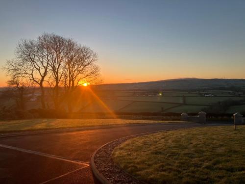 an empty road with the sunset in the background at The Blue Door in Letterkenny