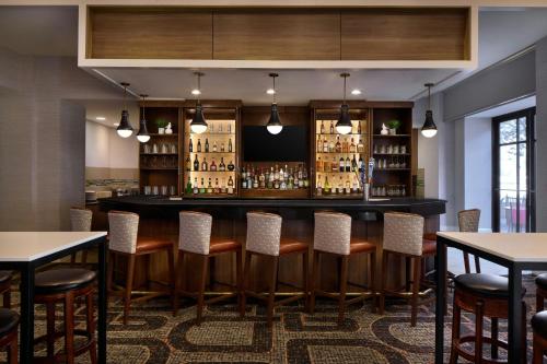 a bar in a restaurant with tables and chairs at Residence Inn Charlotte Uptown in Charlotte