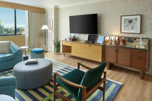 a hotel room with a living area with a television at Sheraton Grand Nashville Downtown in Nashville