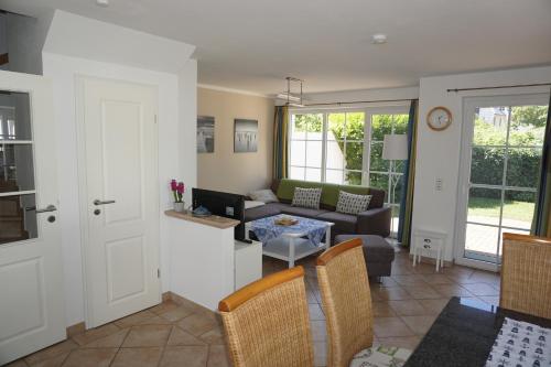 a living room with a couch and a table at Kranich in Zingst