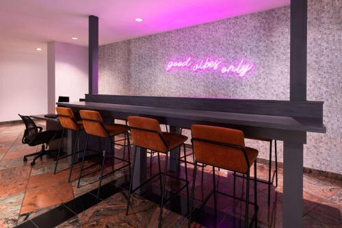 a bar with chairs and a sign that reads goodnight only at Wyndham Garden Norfolk Downtown in Norfolk