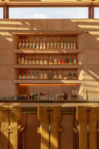 a bar with a lot of bottles and glasses at W Punta de Mita in Punta Mita