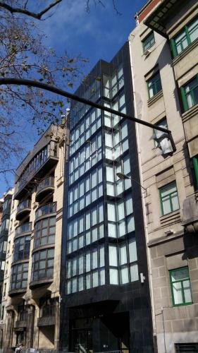 a building with glass windows on the side of it at Hotel Bilbao Plaza in Bilbao