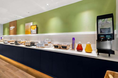a buffet line with food on display in a restaurant at Spark By Hilton Missouri City in Missouri City