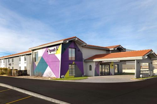 a building with a mural on the side of it at Spark by Hilton Rock Springs in Rock Springs