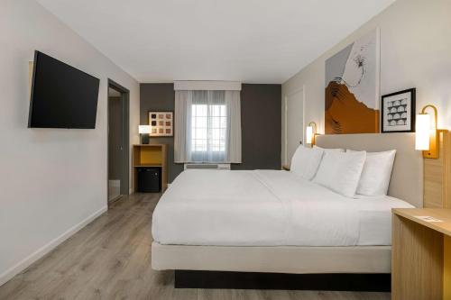 a hotel room with a large bed and a television at Spark by Hilton Rock Springs in Rock Springs