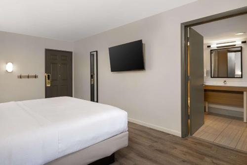 a hotel room with a bed and a television at Spark by Hilton Rock Springs in Rock Springs