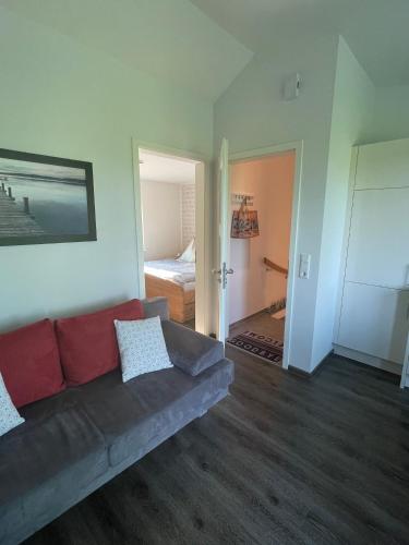 a living room with a couch and a bed at Wilsterberg FeWo "die Kleine" in Ascheffel
