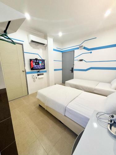 One Stop Hotel Ipohにあるベッド