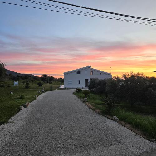 a house on the side of a road at sunset at I Secolari di Giulia in Avola