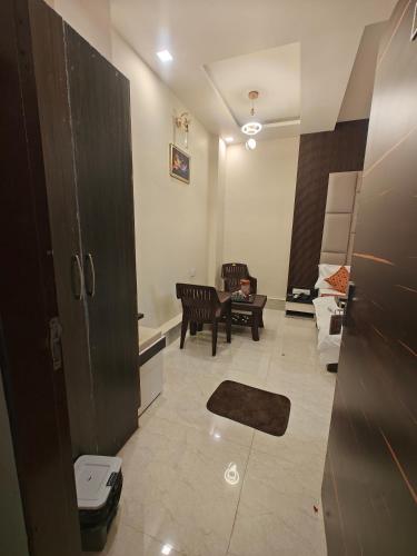 a living room with a couch and a table at Hotel Pink City in Sīkar