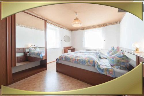 a bedroom with a bed and a large mirror at Ferienwohnung in Waldidylle