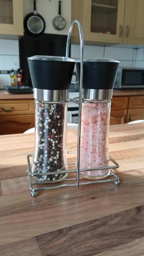 two salt and pepper shakers sitting on a kitchen counter at Ipswich Town 3 Bed House in Copdock