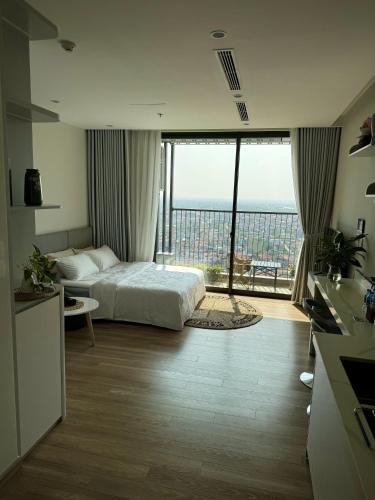 a hotel room with a bed and a large window at Landmark Ecopark by Emily in Town in Kim Quan