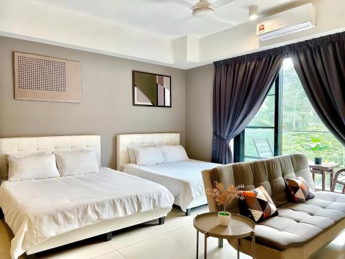 a hotel room with two beds and a couch at Midhills Genting Highlands in Genting Highlands