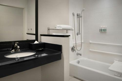 a white bathroom with a sink and a shower at Fairfield by Marriott The Dalles in The Dalles