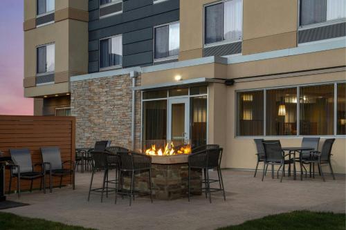 a patio with a fire pit in front of a building at Fairfield by Marriott The Dalles in The Dalles