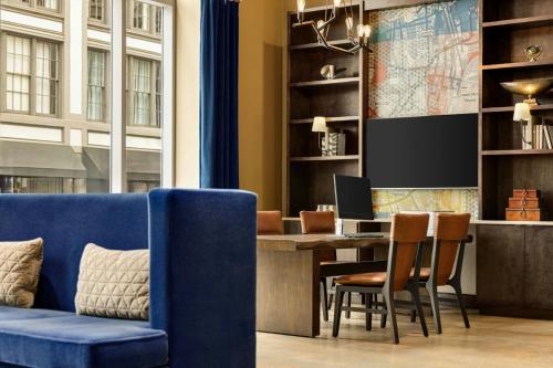an office with a blue couch and a desk with a computer at Fairfield Inn & Suites by Marriott New Orleans Downtown/French Quarter Area in New Orleans