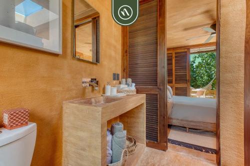 a bathroom with a sink and a tub and a toilet at Stunning Two-bedroom Ocean View House - Mazul in Tlachicón