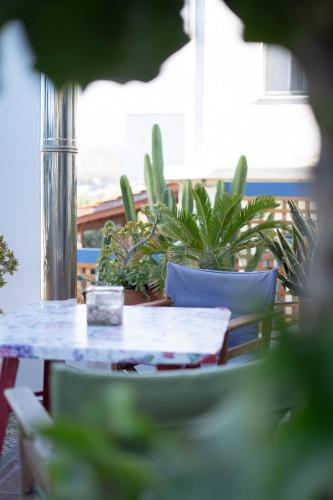 a table and chairs with plants on a balcony at Sissi View in Sissi