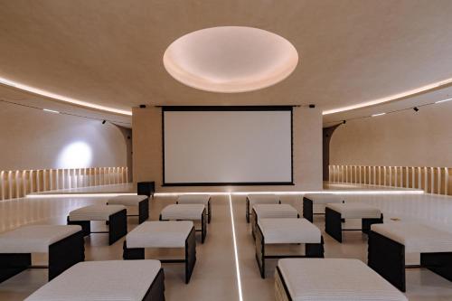 a room with chairs and a projection screen at 大理风雅颂苍洱眼酒店-FYS Hotel in Dali