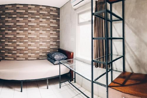 a room with a couch and a glass table at Koja CoLiving in Bandung