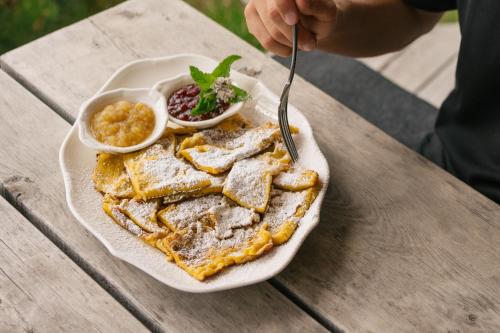 a plate of food on a table with a plate of toast at Zallinger Dolomites in Seiser Alm 