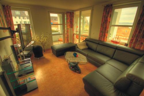 a living room with a couch and a table at Ostseeaussicht in Eckernförde