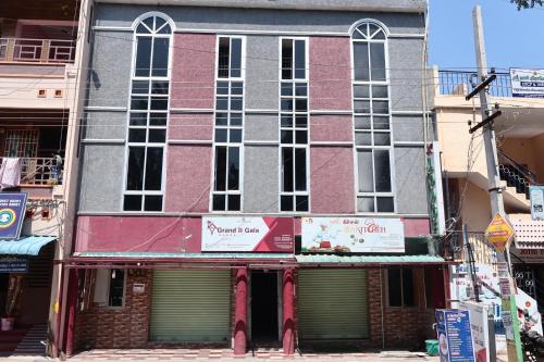 a building with a sign on the front of it at Grand D Gala , Dharmapuri in Dharmapuri