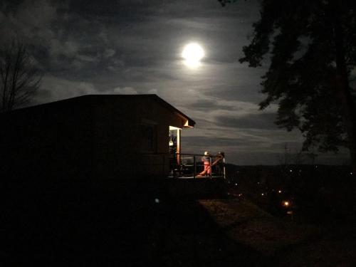 two people sitting on a porch of a house at night at Ferienhaus Cornell in Amtshof