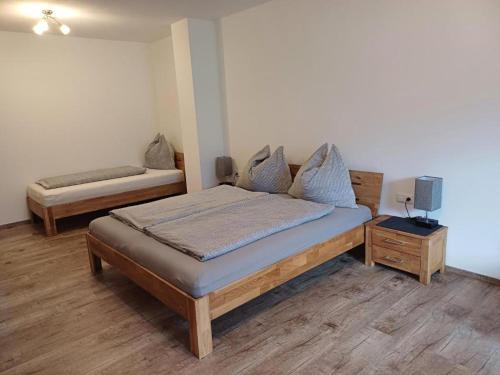a bedroom with a bed and a nightstand with a bed sidx sidx sidx sidx at Ferienwohnung Kramerhof in Ebbs