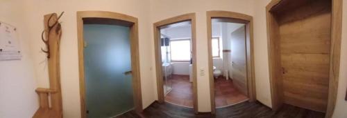 a hallway with two mirrors in a room at Ferienwohnung Kramerhof in Ebbs