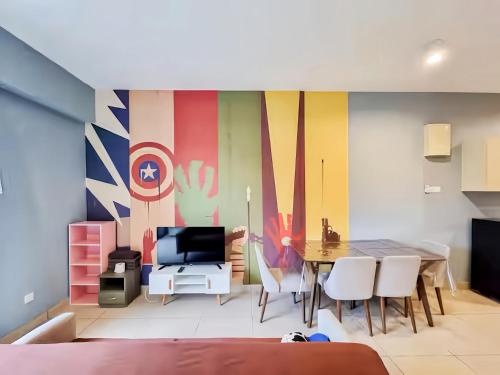 a living room with a table and a colorful wall at Midhills Genting Highlands in Genting Highlands