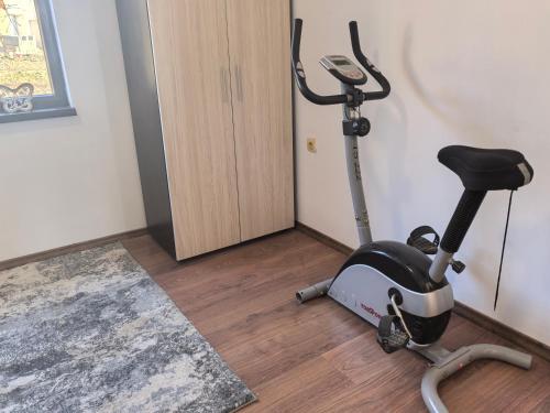 a room with a exercise bike and a treadmill at Харизма in Hisarya