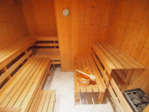 an empty sauna with two benches and a bucket at Galerie F West in Gingst