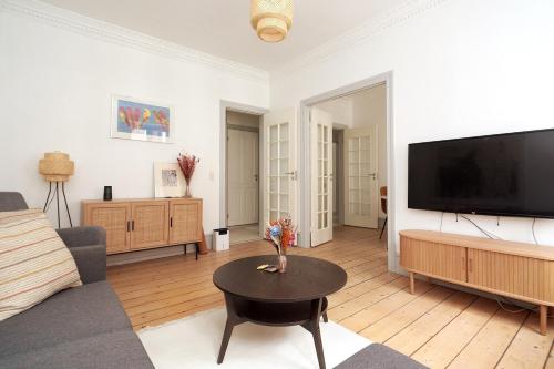 a living room with a large flat screen tv at Family - Central - Sea - Luxury in Copenhagen