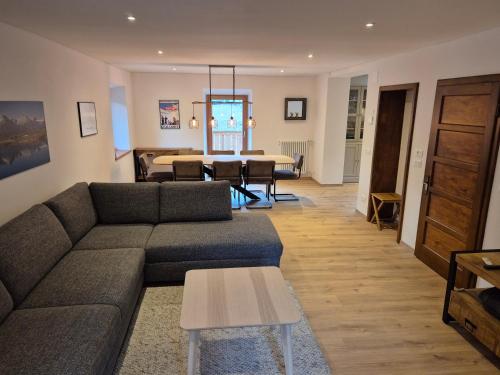 a living room with a couch and a table at Casa Sasso Bianco in Rocca Pietore